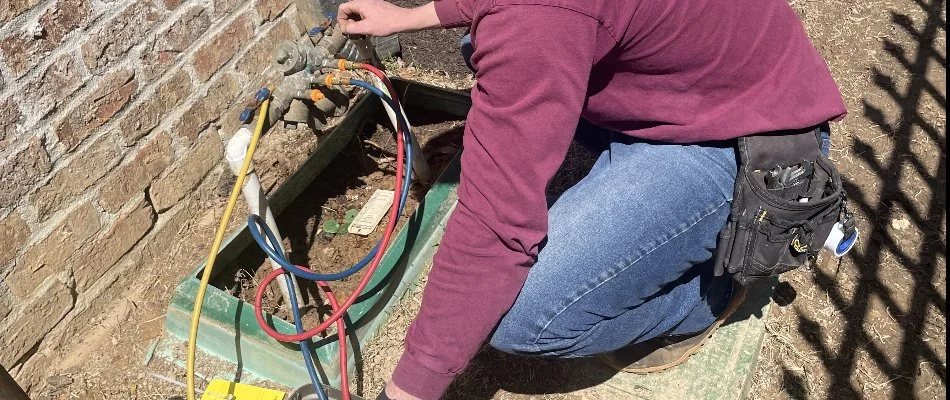 Professional looking at irrigation system controls in Memphis, TN.