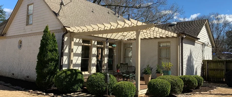 Patio in Memphis, TN, with a white wood pergola.