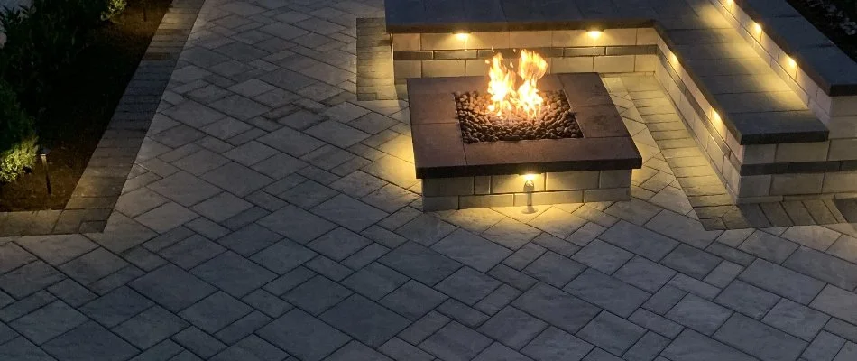 Paver patio in Memphis, TN, with a fire pit and seating wall.